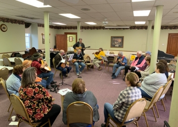 People playing musical instruments and singing at Hope Hootenanny