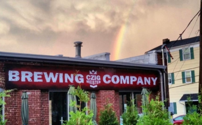 Czig Meister Brewing Company sign with rainbow in background