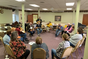 People playing musical instruments and singing at Hope Hootenanny