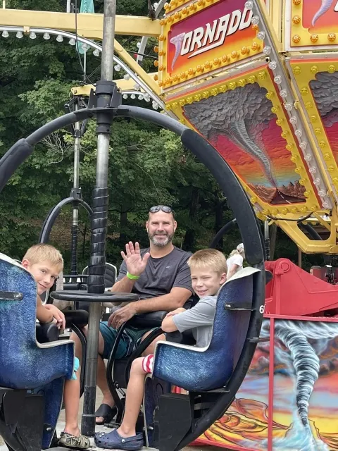 Dad with two boys on LOMB Tornado ride 